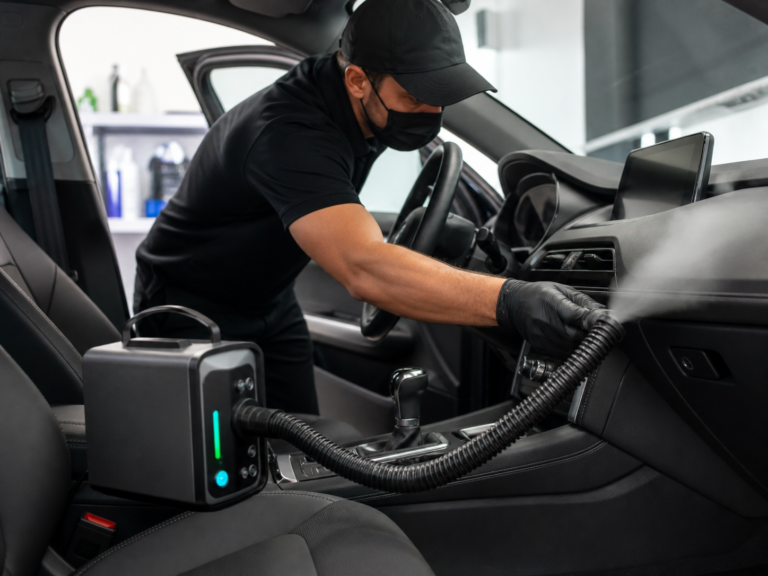 Professional automotive odor treatment inside a vehicle cabin